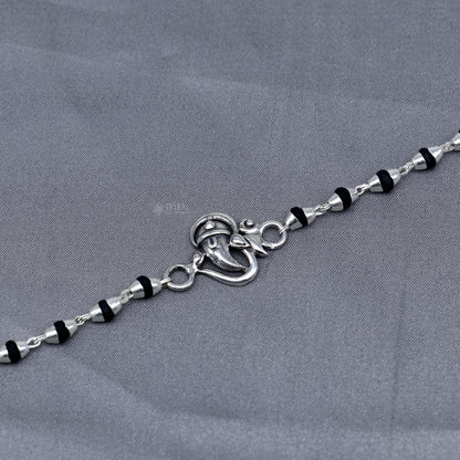Sterling silver Lord Ganesha bracelet with black Tulsi beads, handmade Hindu prayer beads and rakhi from Tribal Ornaments.