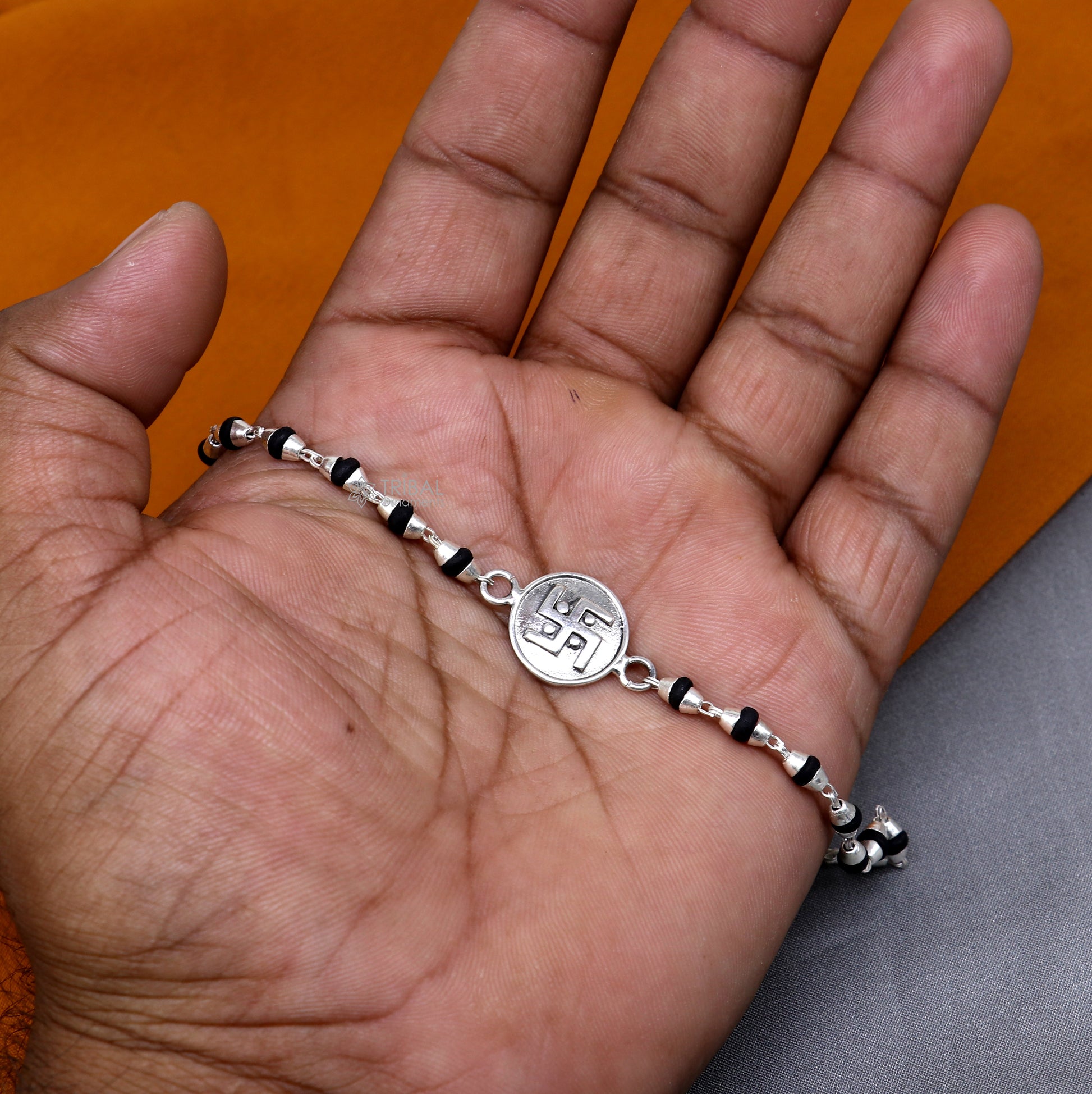 Sterling silver Swastik design black Tulsi beads bracelet with holy basil rosary beads from Tribal Ornaments.