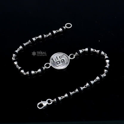 Sterling silver Swastik design black Tulsi beads bracelet with holy basil beads, crafted by TRIBAL ORNAMENTS.