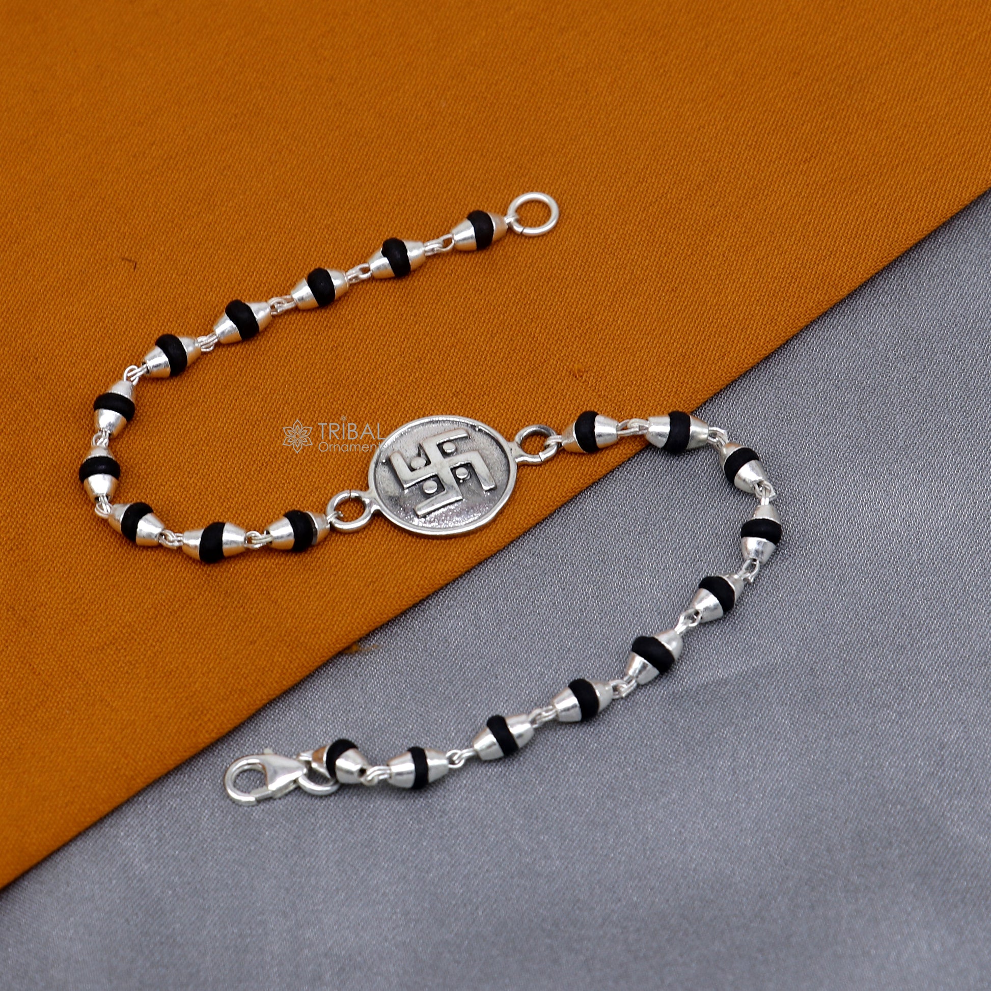 Sterling silver Swastik design black Tulsi beads bracelet with holy basil beads, crafted by TRIBAL ORNAMENTS.