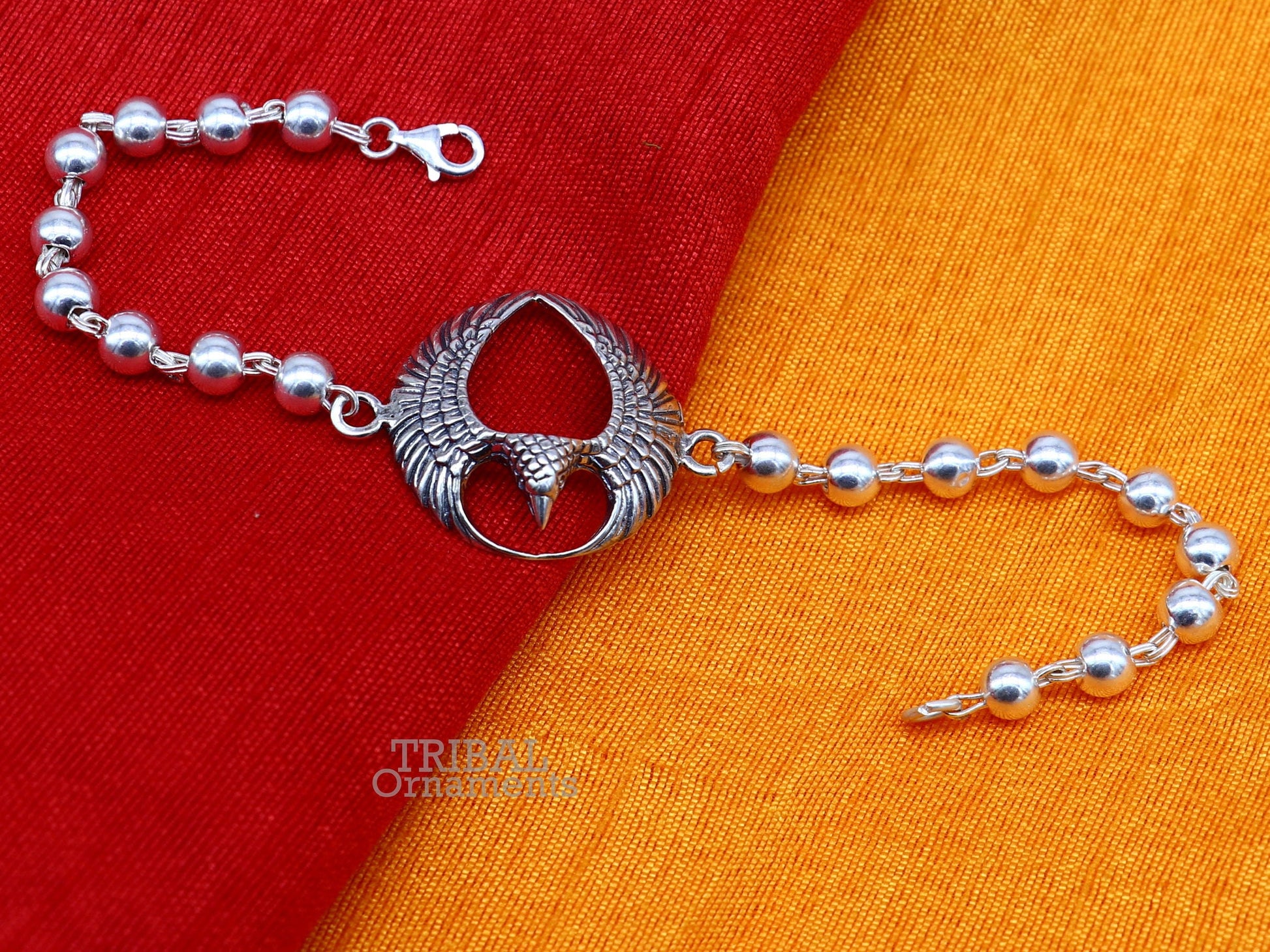 925 silver Lord Garuda design Tulsi beaded bracelet rakhi by TRIBAL ORNAMENTS featuring black basil beads and intricate silver craftsmanship.