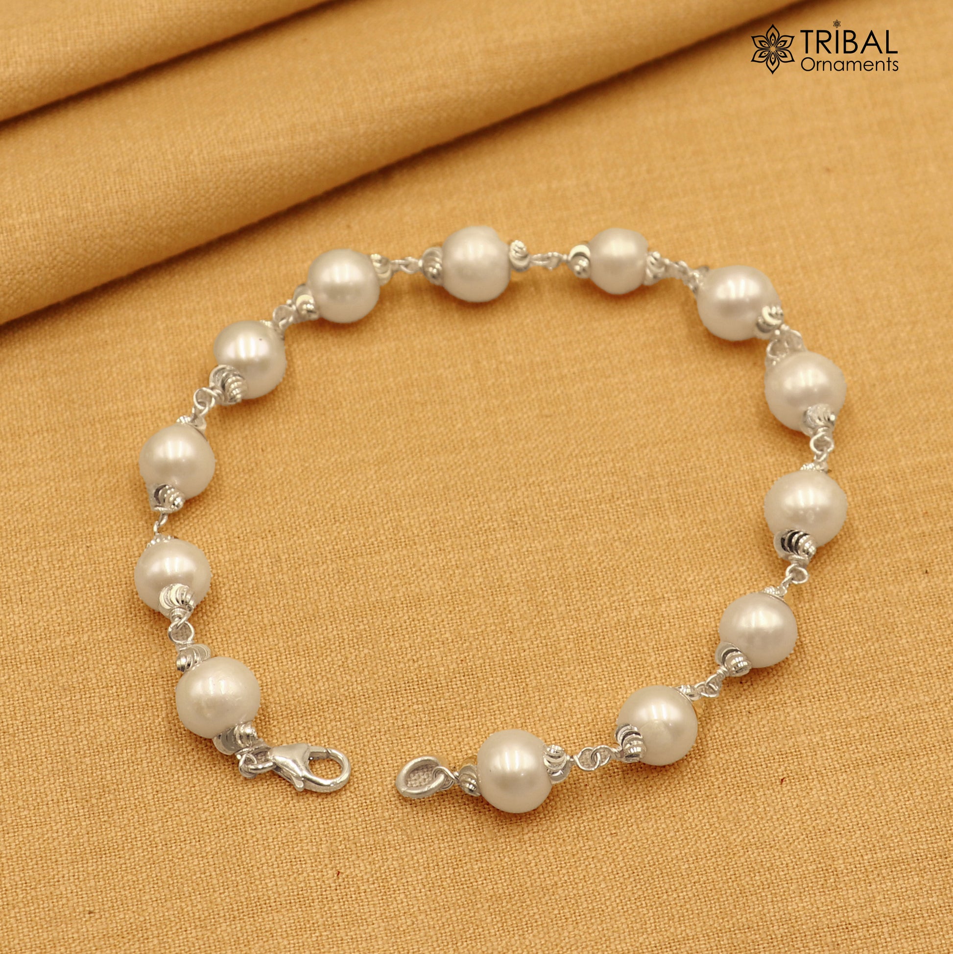 925 Sterling silver pearl beads bracelet for unisex jewelry by TRIBAL ORNAMENTS, featuring a 6-inch silver bracelet with pearl accents.