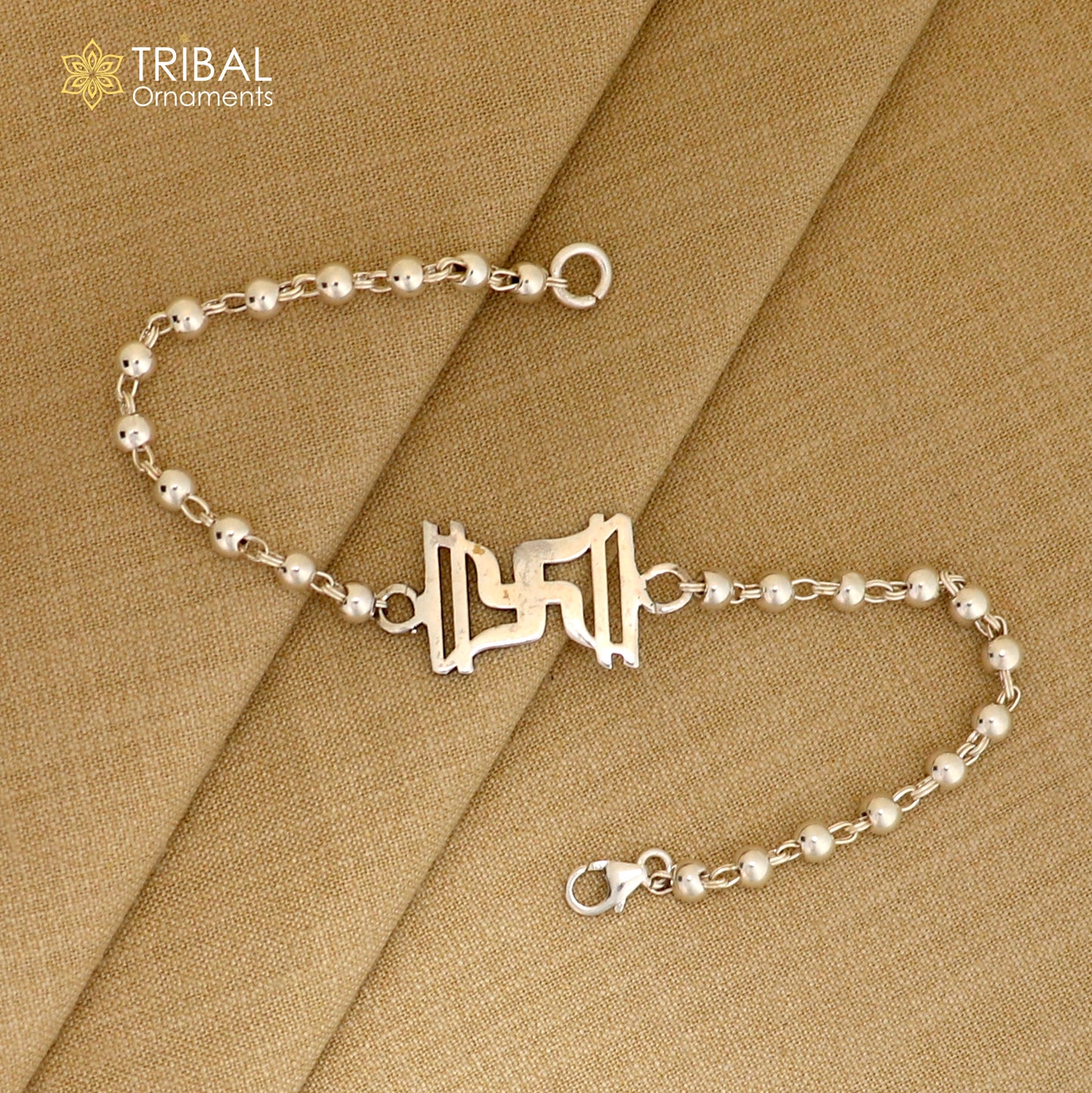 Sterling silver Swastik design Rudraksh and black tulsi beads bracelet rakhi with silver beads by TRIBAL ORNAMENTS.