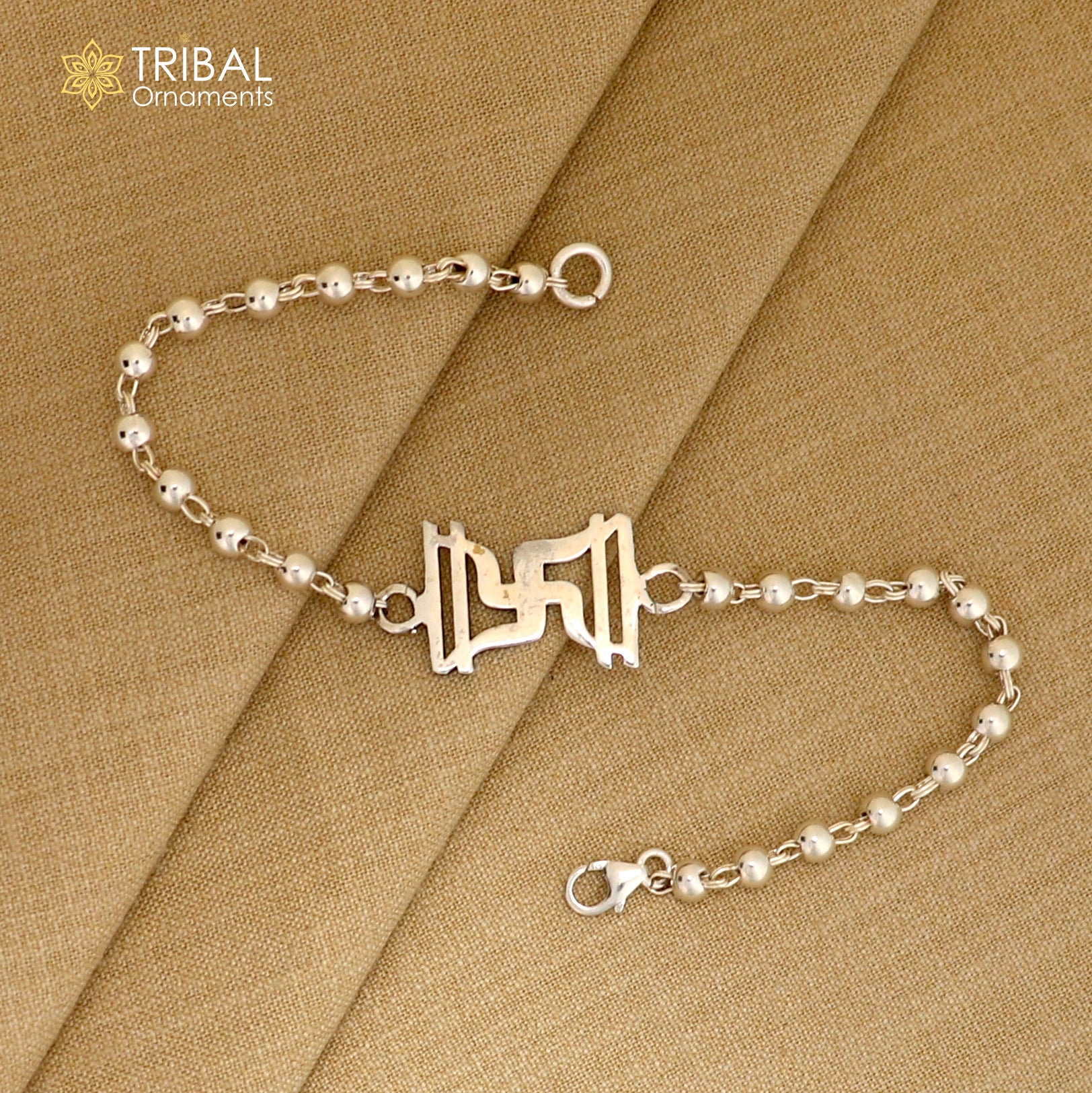 Sterling silver Swastik design Rudraksh and black tulsi beads bracelet rakhi with silver beads by TRIBAL ORNAMENTS.