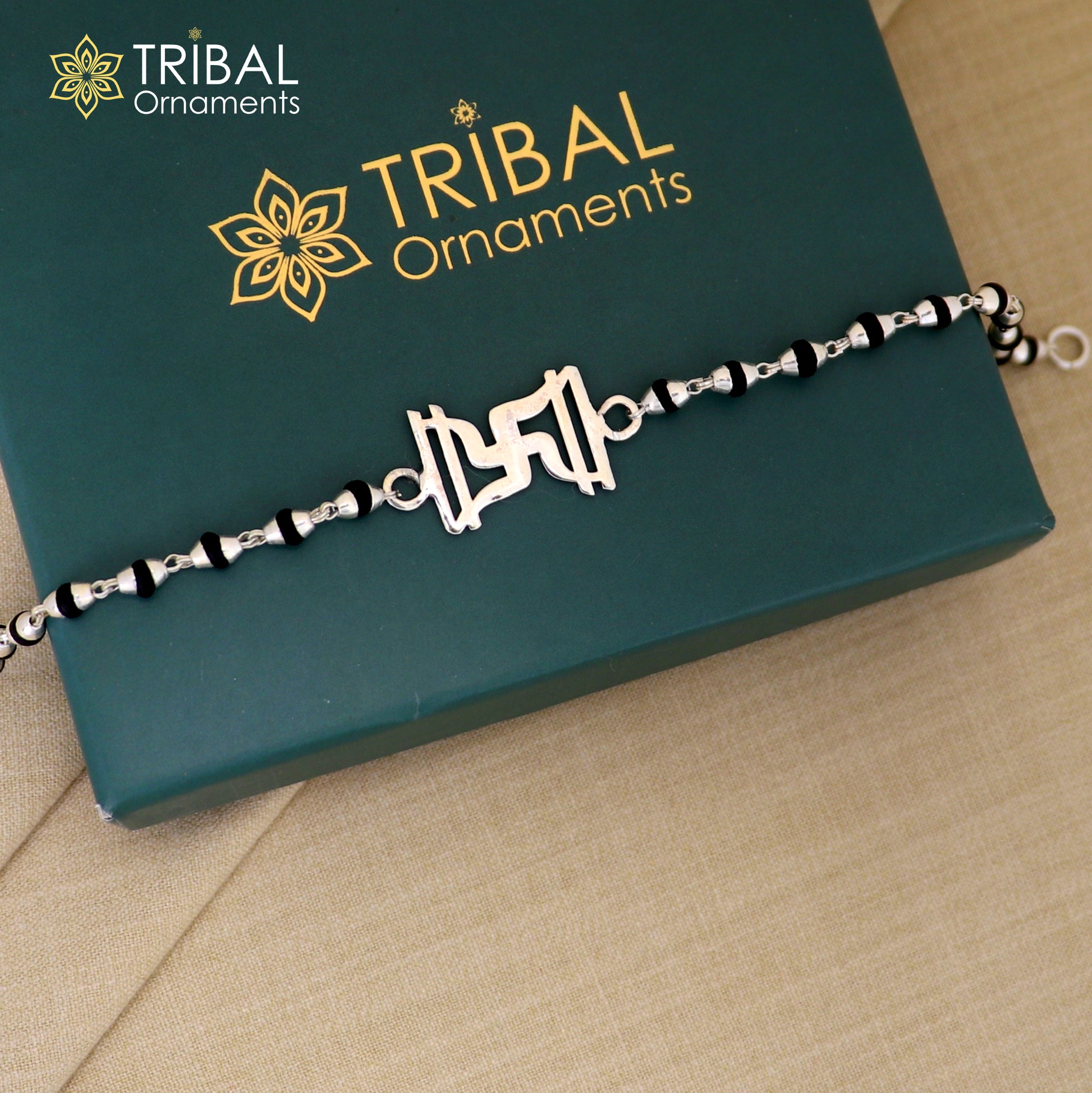 Sterling silver Swastik design Rudraksh bracelet with black Tulsi beads and silver chain, crafted by TRIBAL ORNAMENTS.