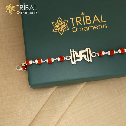 Sterling silver Swastik design Rudraksh and black tulsi beaded bracelet rakhi with silver accents, handmade by TRIBAL ORNAMENTS.