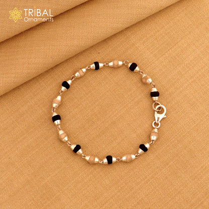 Unisex bracelet featuring black basil rosary beads, sterling silver and wood tulsi plant beads, stylish tribal jewelry design