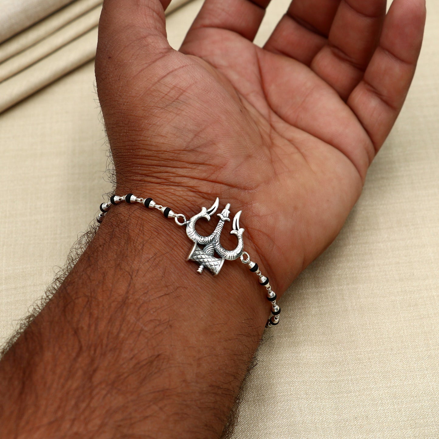 Sterling silver Trishul bracelet with black Tulsi beads, unisex design by TRIBAL ORNAMENTS, 7.5 inches, Trident motif.
