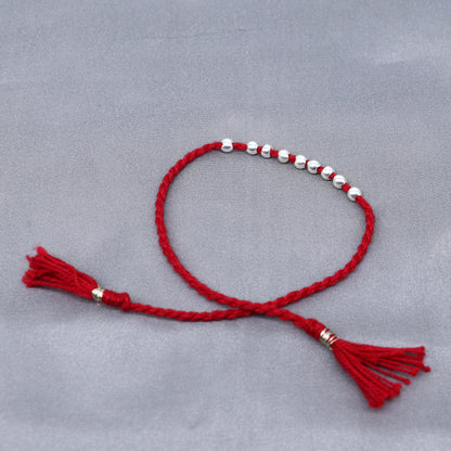 925 sterling silver ball design thread rakhi bracelet by TRIBAL ORNAMENTS with traditional decorative elements for Rakshabandhan.