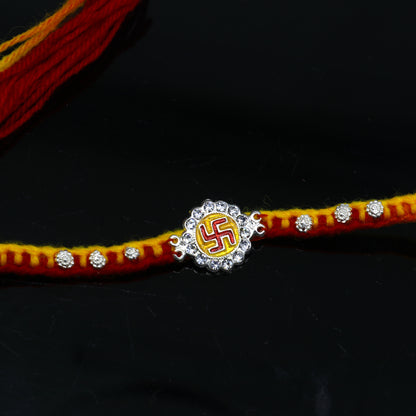 925 sterling silver SWASTIKA design thread rakhi bracelet by TRIBAL ORNAMENTS, featuring traditional silver craftsmanship for Rakshabandhan.