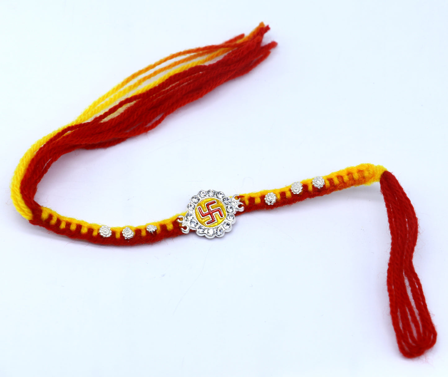 Sterling silver SWASTIKA design thread rakhi bracelet by TRIBAL ORNAMENTS, featuring intricate tribal-inspired pattern and silver craftsmanship.