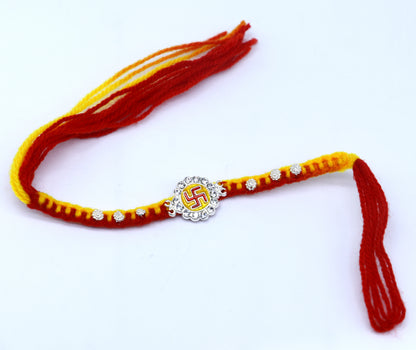 Sterling silver SWASTIKA design thread rakhi bracelet by TRIBAL ORNAMENTS, featuring intricate tribal-inspired pattern and silver craftsmanship.
