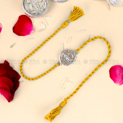 Sterling silver Ganesha design thread bracelet with red thread, crafted by TRIBAL ORNAMENTS.