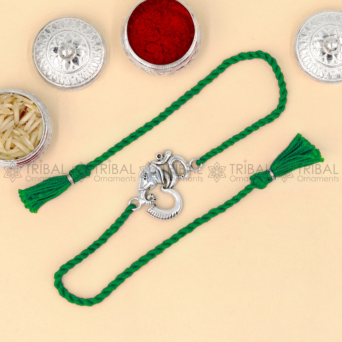 Sterling silver Ganesha Om design thread bracelet with red thread and pendant, by TRIBAL ORNAMENTS.