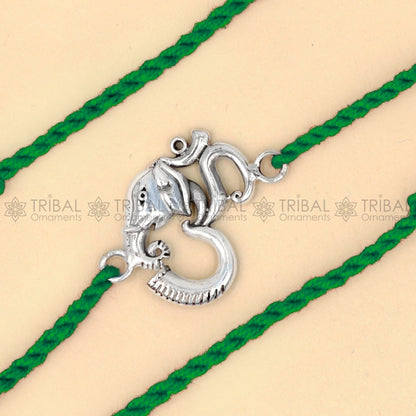 925 Sterling silver Ganesha Om thread bracelet with red thread and intricate pendant by TRIBAL ORNAMENTS.