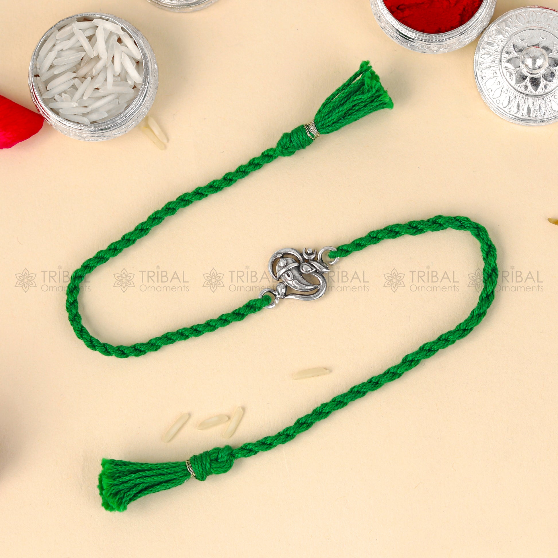 925 Sterling silver Ganesha design thread bracelet with red thread by TRIBAL ORNAMENTS, featuring a detailed Ganesha pendant.