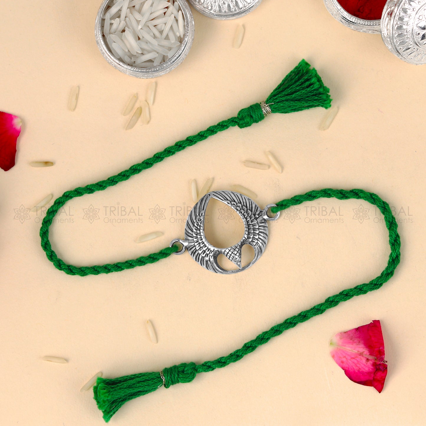 Sterling silver Garuda design thread rakhi bracelet with red thread from TRIBAL ORNAMENTS, ideal for Rakshabandhan celebrations.