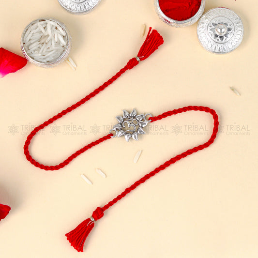 Sterling silver Om design thread rakhi bracelet with red thread and Garuda pendant by TRIBAL ORNAMENTS for Rakshabandhan.