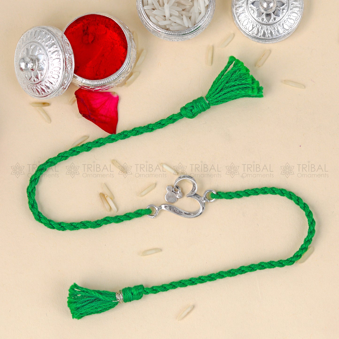 Sterling silver heart design thread bracelet by Tribal Ornaments with red thread and silver pendant, model RK361.