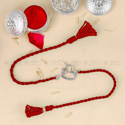 Sterling silver heart design thread bracelet by Tribal Ornaments with red thread and silver pendant.