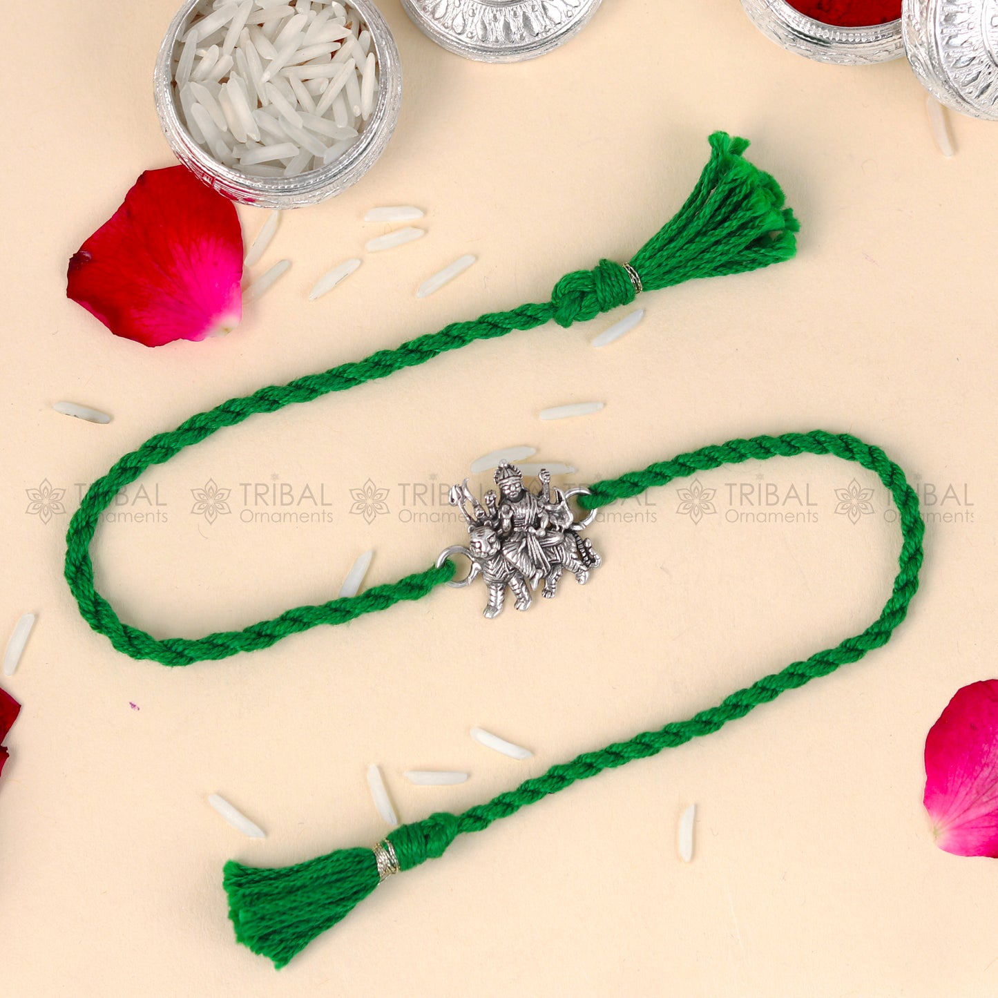 Sterling silver Lord Durga Maa design thread rakhi bracelet by TRIBAL ORNAMENTS with red thread and intricate pendant.