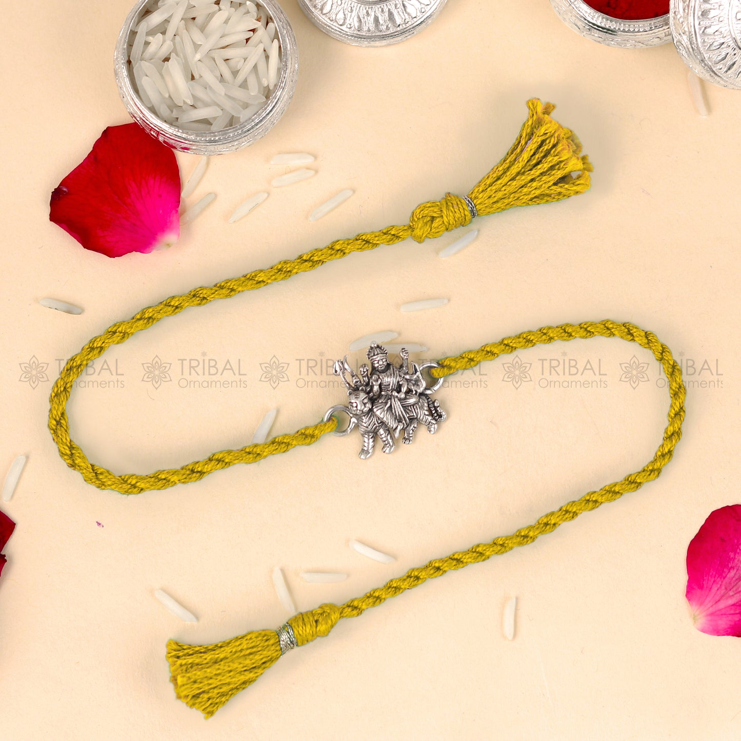 925 Sterling silver Lord Durga Maa design thread rakhi bracelet with red thread from TRIBAL ORNAMENTS, featuring a detailed pendant.
