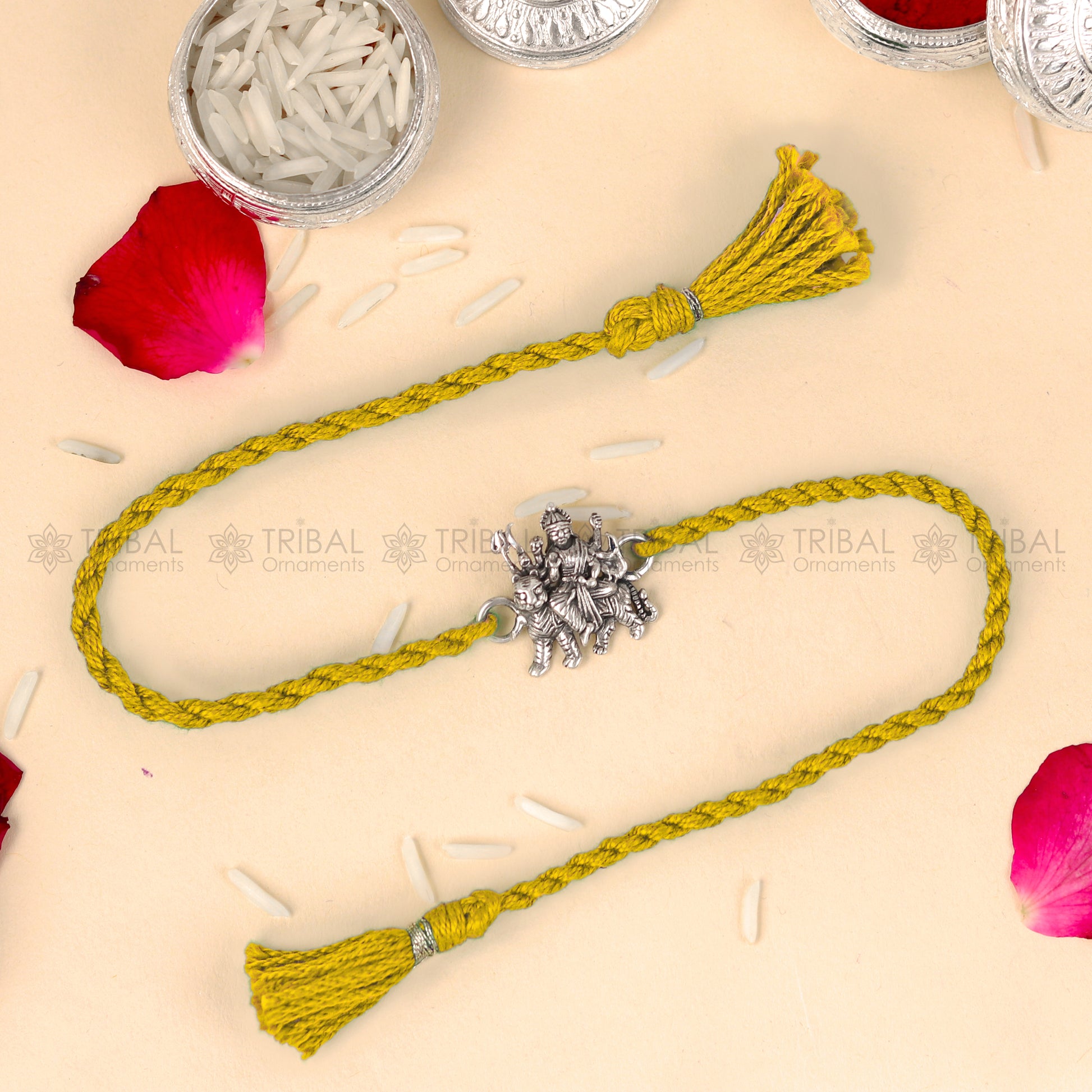 925 Sterling silver Lord Durga Maa design thread rakhi bracelet with red thread from TRIBAL ORNAMENTS, featuring a detailed pendant.