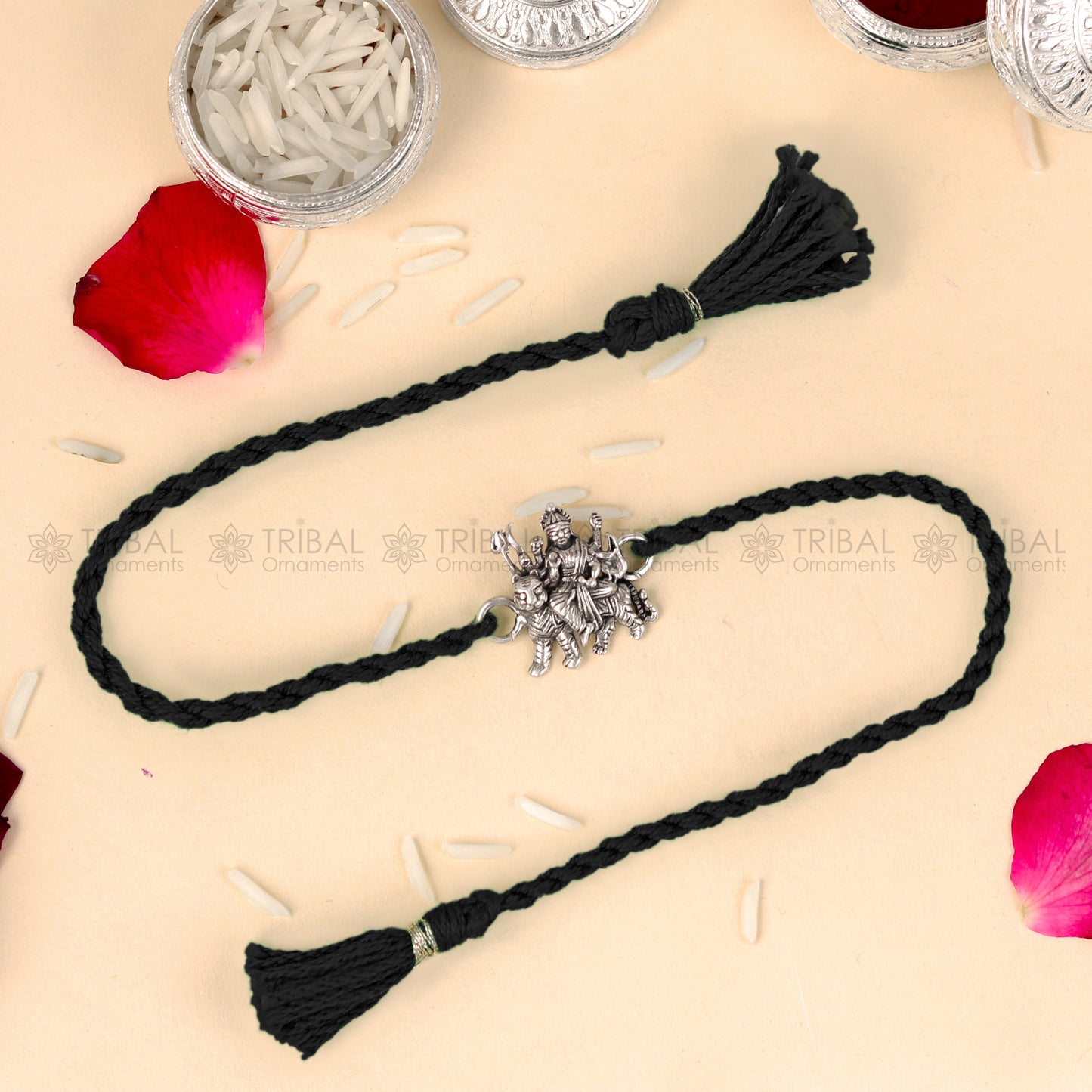 925 Sterling silver Lord Durga Maa design thread rakhi bracelet with red thread from TRIBAL ORNAMENTS, featuring a detailed pendant.
