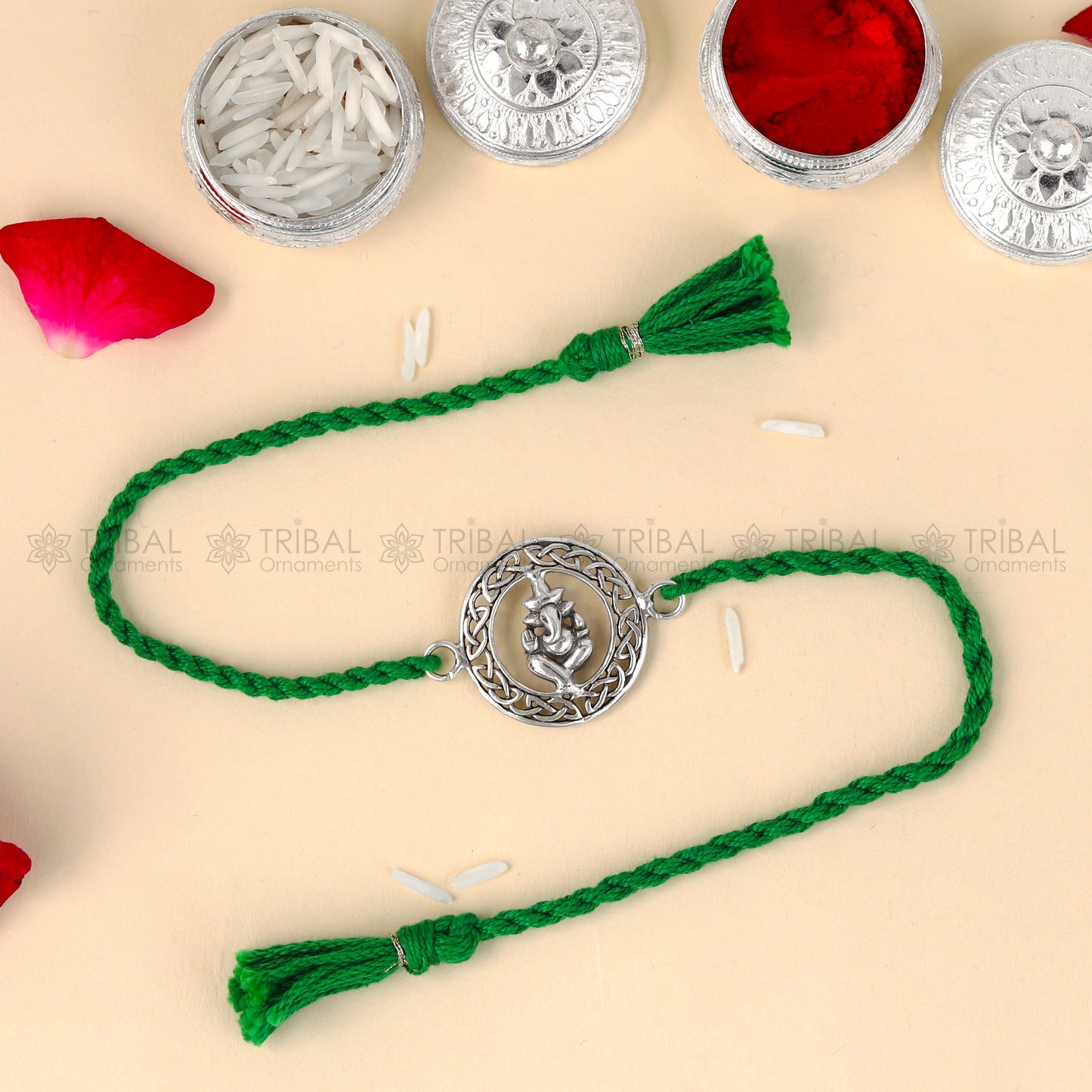 Sterling silver Lord Ganesha thread bracelet from TRIBAL ORNAMENTS with red thread and Ganesha pendant design.