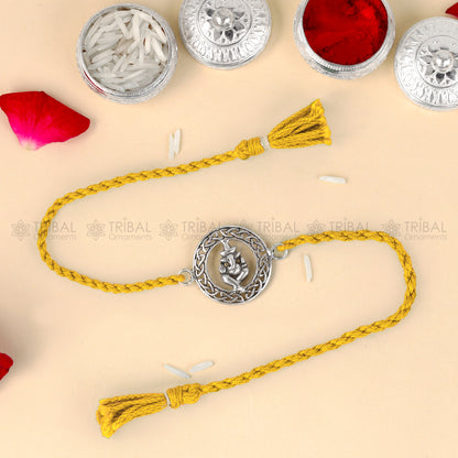 Sterling silver Lord Ganesha design thread rakhi bracelet with red thread from TRIBAL ORNAMENTS, featuring intricate Ganesha pendant.