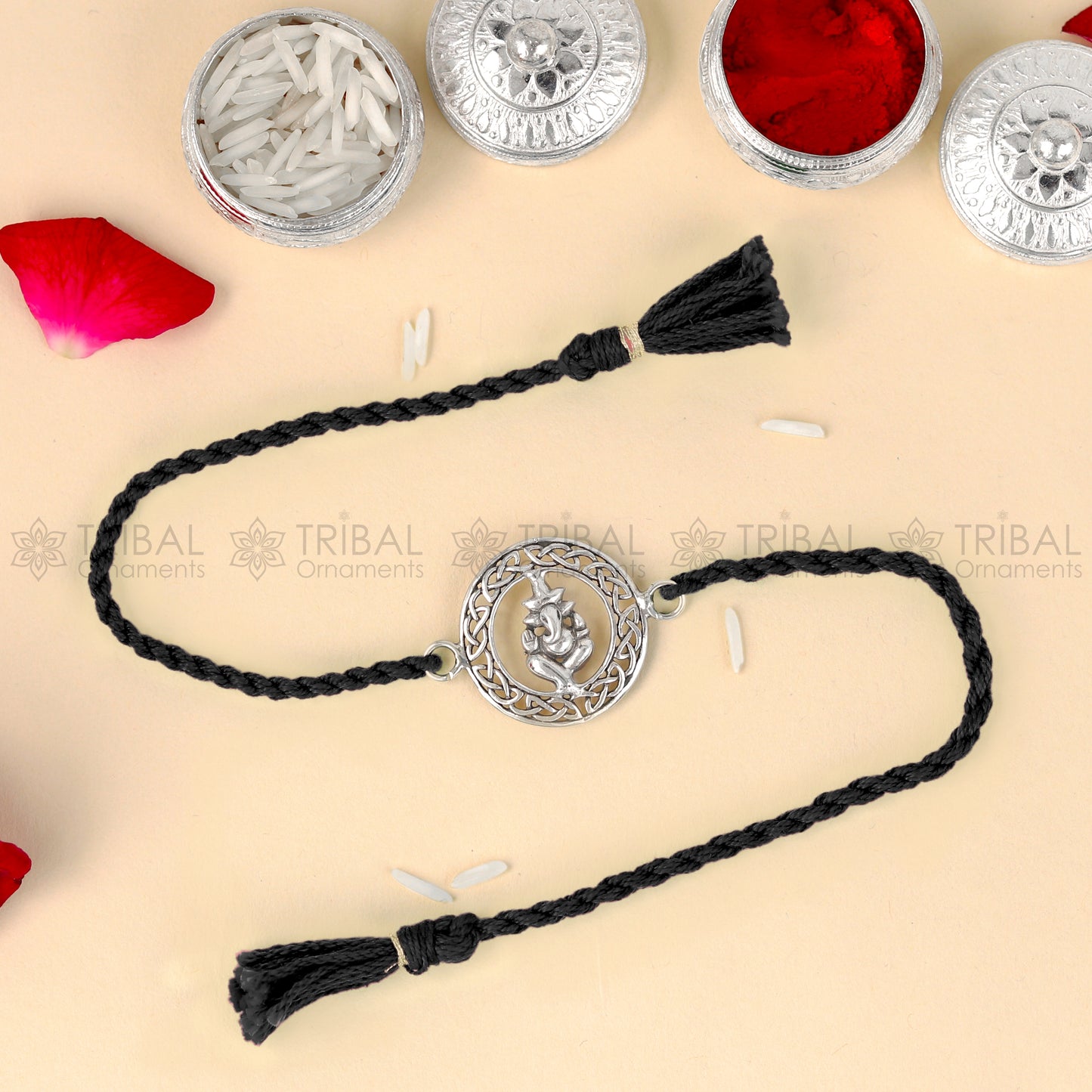 Sterling silver Lord Ganesha design thread rakhi bracelet with red thread and intricate pendant, by TRIBAL ORNAMENTS.
