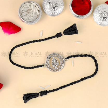Sterling silver Lord Ganesha design thread rakhi bracelet with red thread and intricate pendant, by TRIBAL ORNAMENTS.