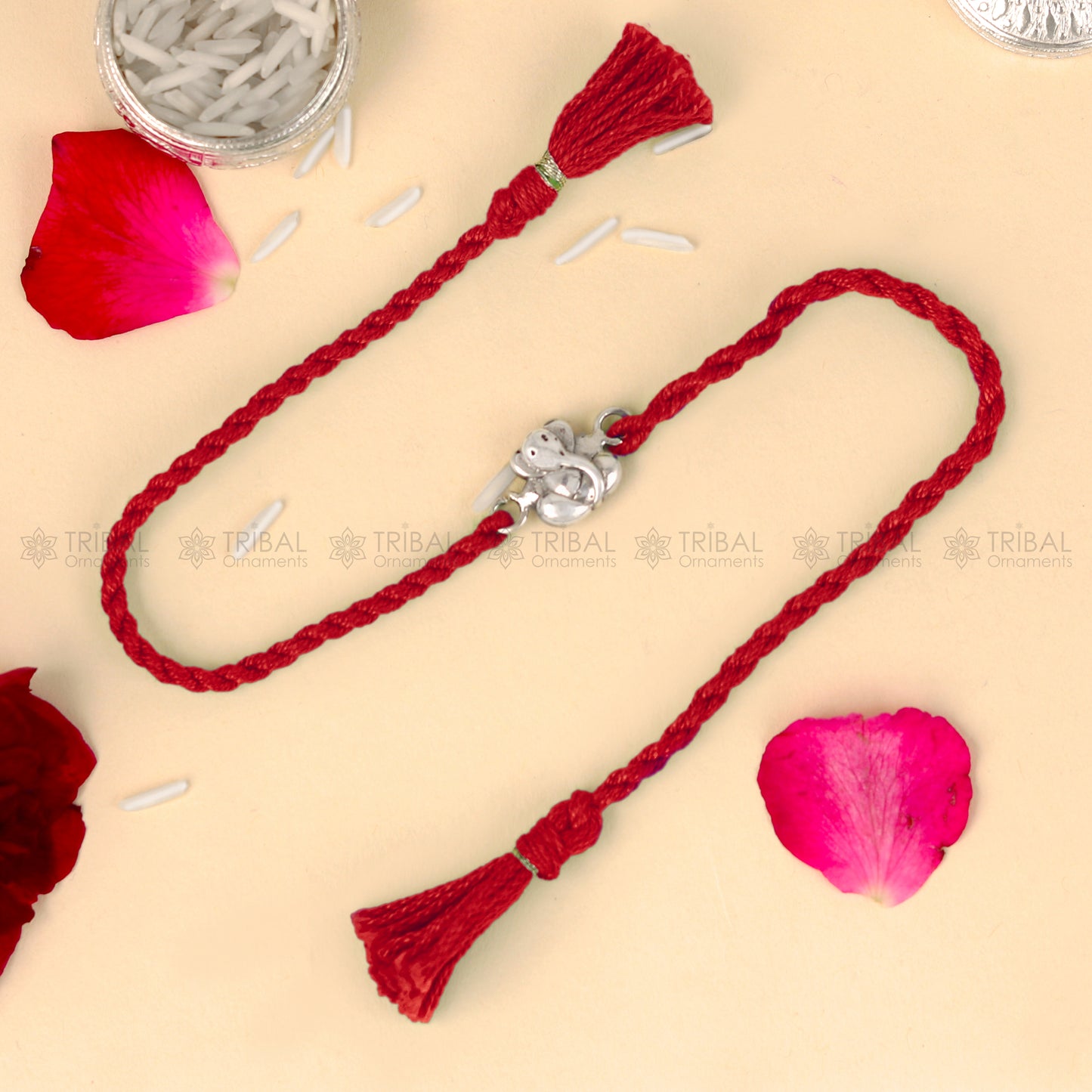 Sterling silver Lord Ganesha design thread bracelet with red thread from TRIBAL ORNAMENTS, featuring intricate Ganesha pendant.