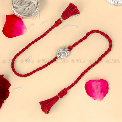 Sterling silver Lord Ganesha design thread bracelet with red thread from TRIBAL ORNAMENTS, featuring intricate Ganesha pendant.