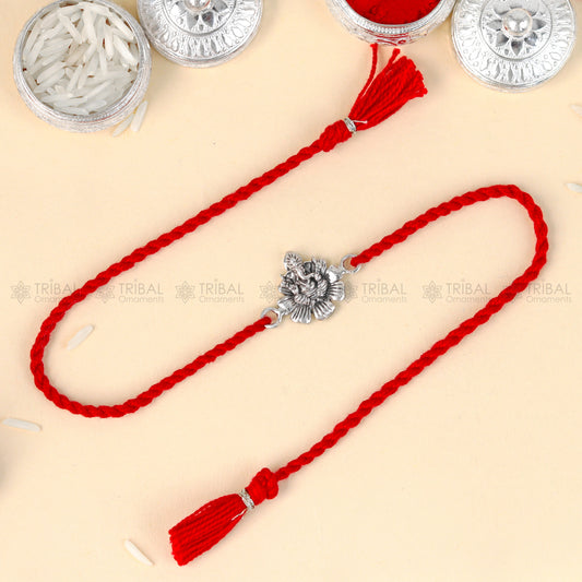 Sterling silver Lord Ganesha design thread bracelet with red thread by TRIBAL ORNAMENTS, featuring detailed pendant.