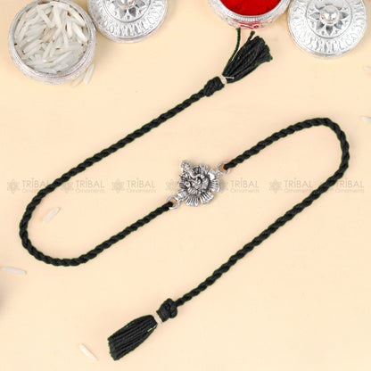 Sterling silver Lord Ganesha pendant bracelet with red thread, handcrafted by TRIBAL ORNAMENTS.