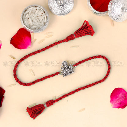 Sterling silver Lord Ganesha design thread bracelet with red thread from TRIBAL ORNAMENTS, featuring intricate pendant detail.