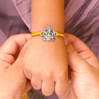 Sterling silver Lord Ganesha design thread bracelet with red thread from TRIBAL ORNAMENTS, featuring detailed Ganesha pendant.