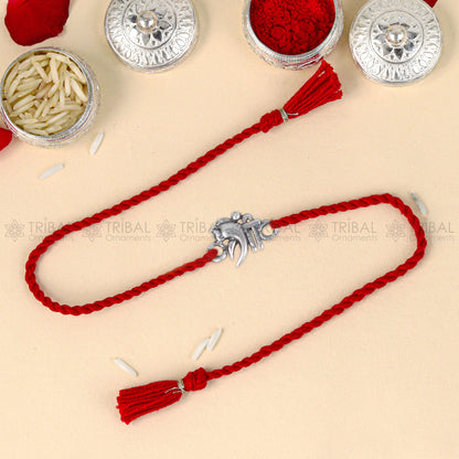 Sterling silver Lord Ganesha design thread bracelet with red thread and pendant, by TRIBAL ORNAMENTS.