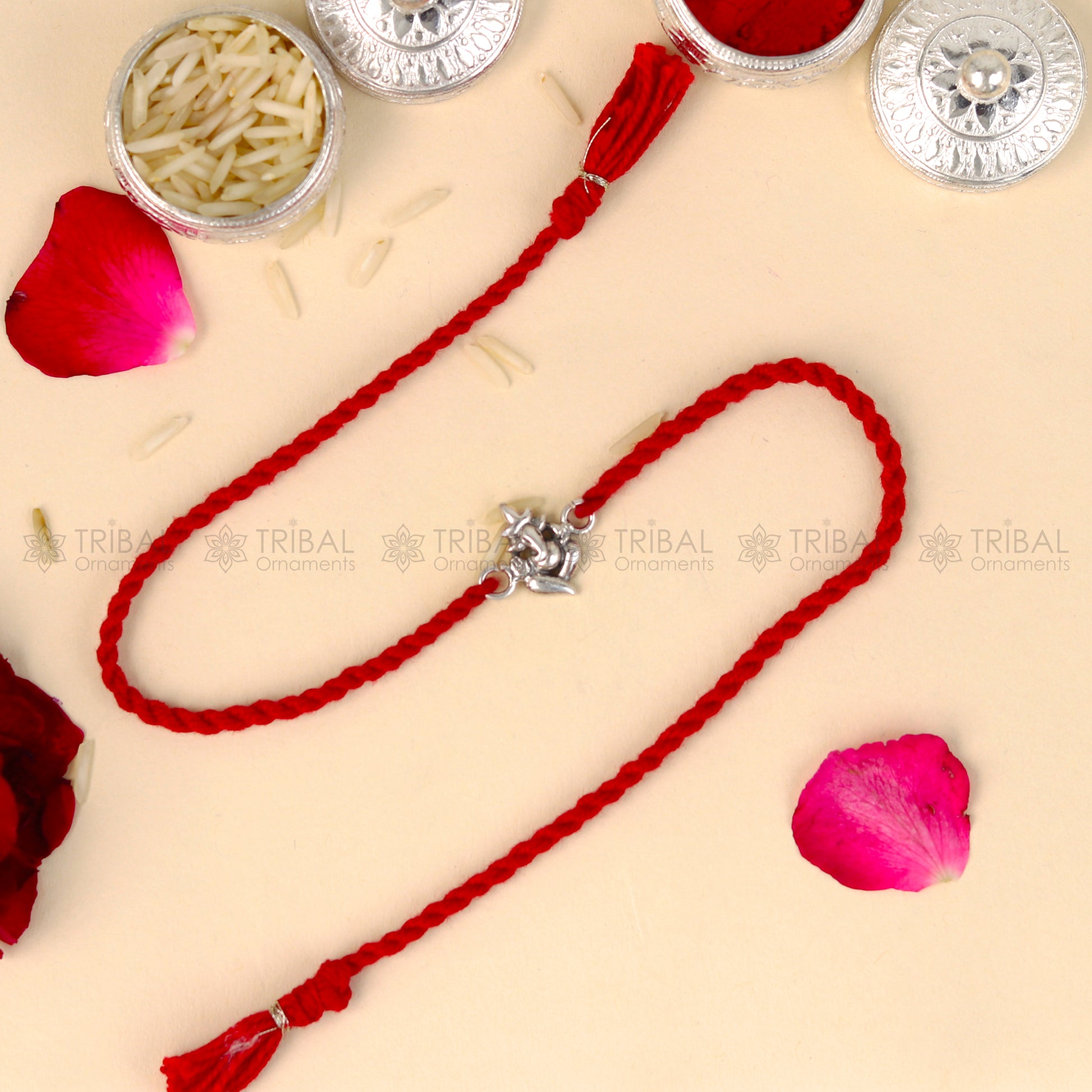 925 Sterling silver Lord Ganesha thread rakhi bracelet with red thread and Ganesha pendant from TRIBAL ORNAMENTS.