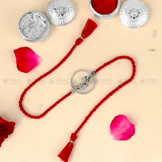 Sterling silver Lord Hanuman design thread rakhi bracelet with red thread from TRIBAL ORNAMENTS.