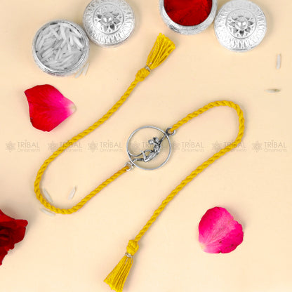 Sterling silver Lord Hanuman design thread bracelet with red thread from TRIBAL ORNAMENTS, featuring detailed pendant.