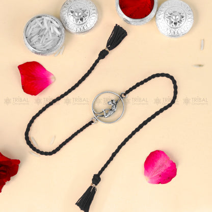 Sterling silver Lord Hanuman design thread rakhi bracelet with red thread from TRIBAL ORNAMENTS, featuring intricate pendant details.