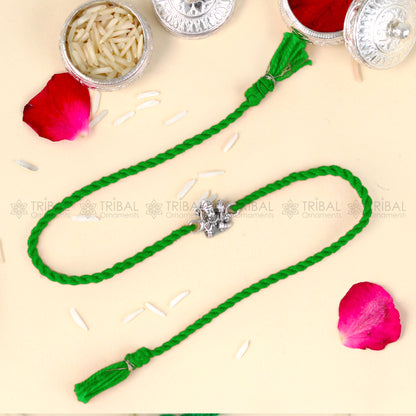 Sterling silver Lord Hanuman Ji design thread rakhi bracelet with red thread from TRIBAL ORNAMENTS, featuring detailed pendant.
