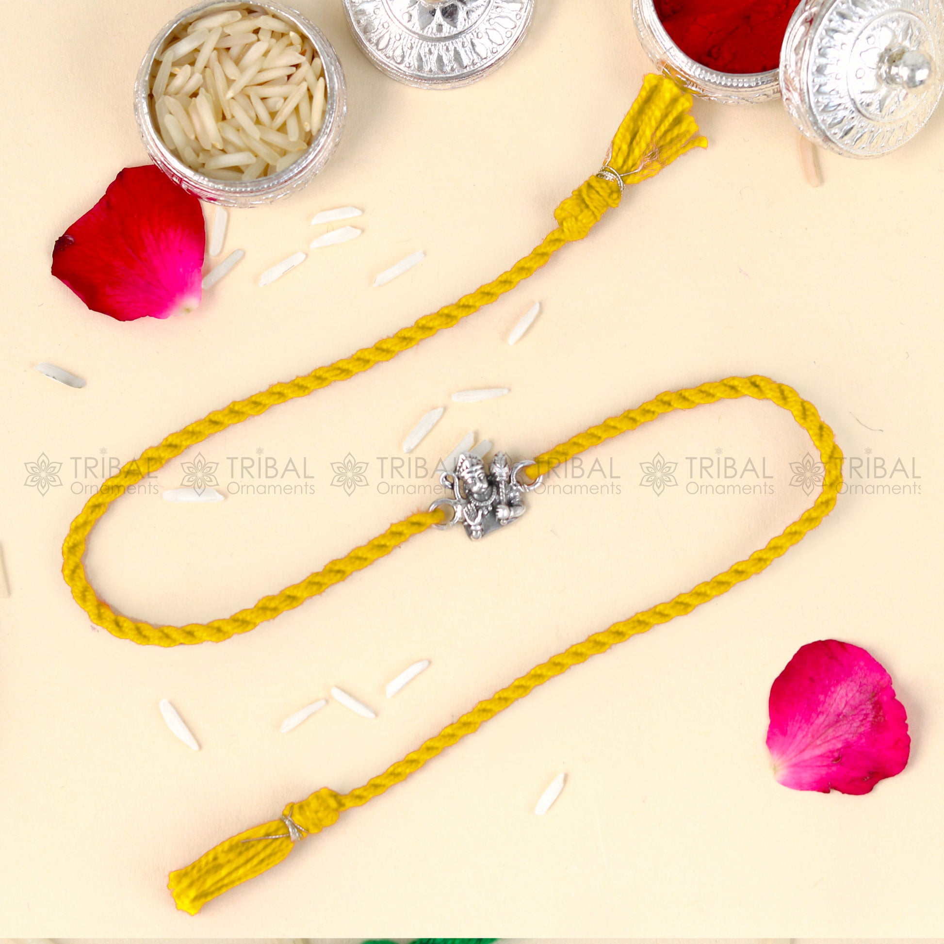 Sterling silver Lord Hanuman design thread rakhi bracelet with red thread from Tribal Ornaments, featuring detailed pendant.