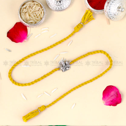 Sterling silver Lord Hanuman design thread rakhi bracelet with red thread from Tribal Ornaments, featuring detailed pendant.