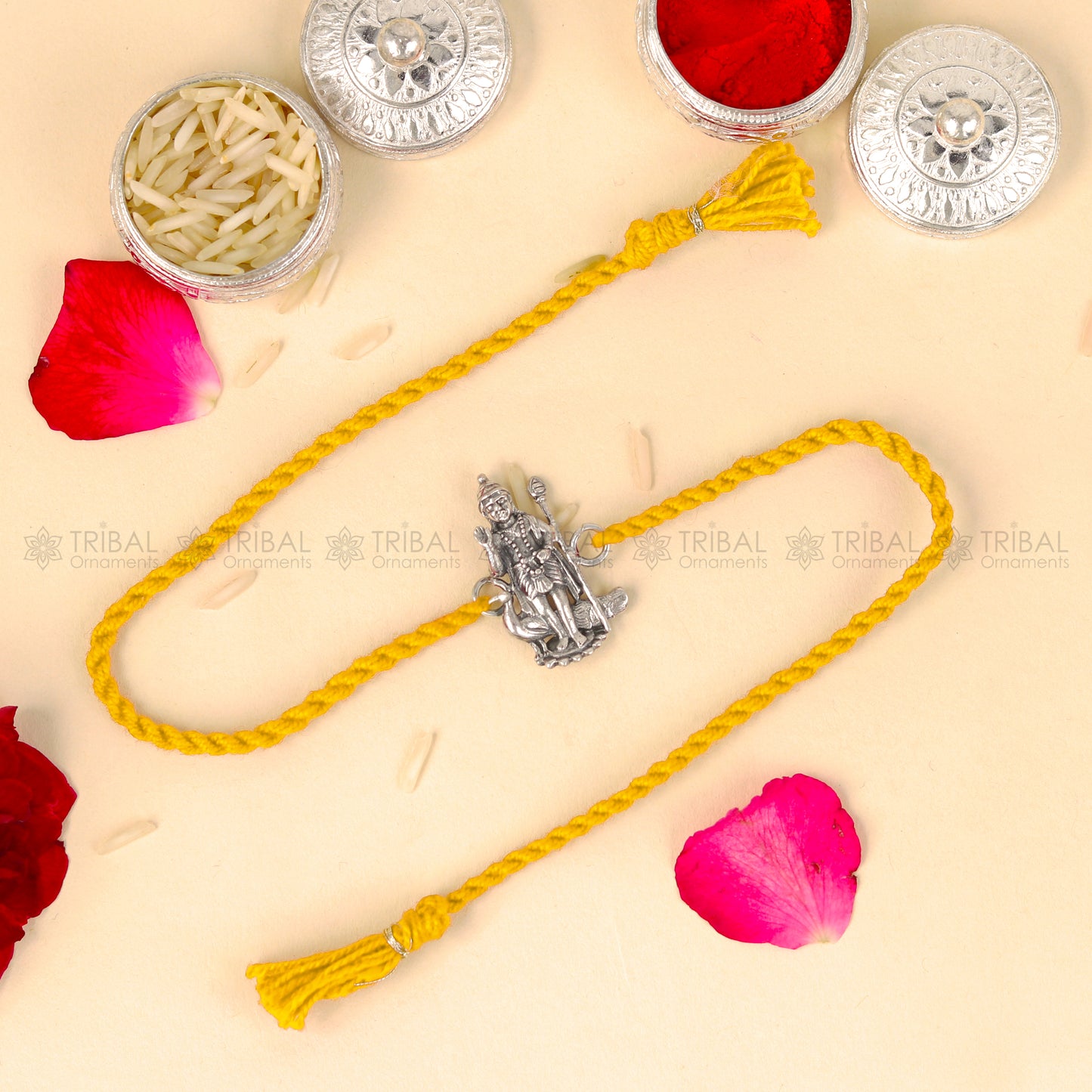 Sterling silver Lord Karthikeya design thread rakhi bracelet with red thread by TRIBAL ORNAMENTS.
