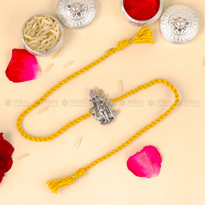 Sterling silver Lord Karthikeya design thread rakhi bracelet with red thread by TRIBAL ORNAMENTS.