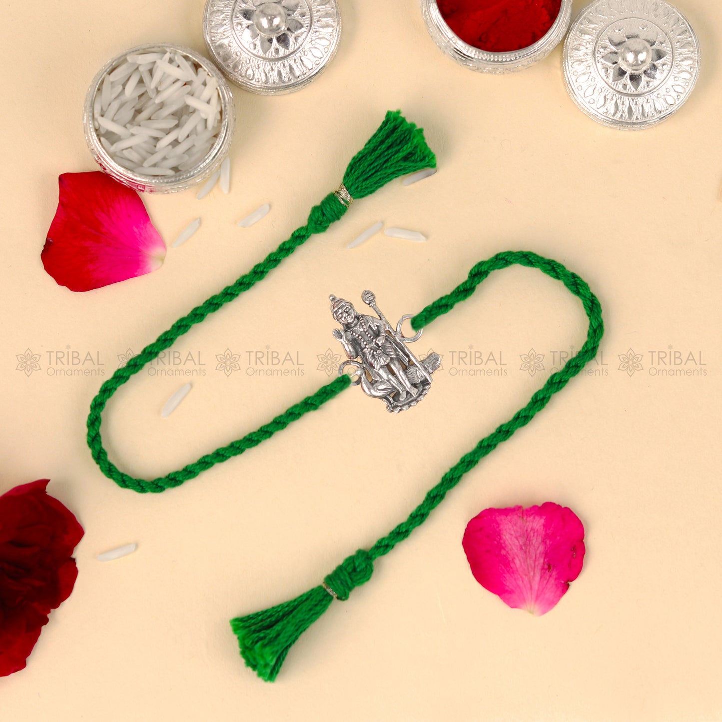 Sterling silver Lord Karthikeya thread bracelet by TRIBAL ORNAMENTS with red thread and detailed pendant design.