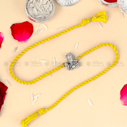 925 Sterling silver Lord Krishna design thread rakhi bracelet with red thread from TRIBAL ORNAMENTS, featuring a detailed Krishna pendant.